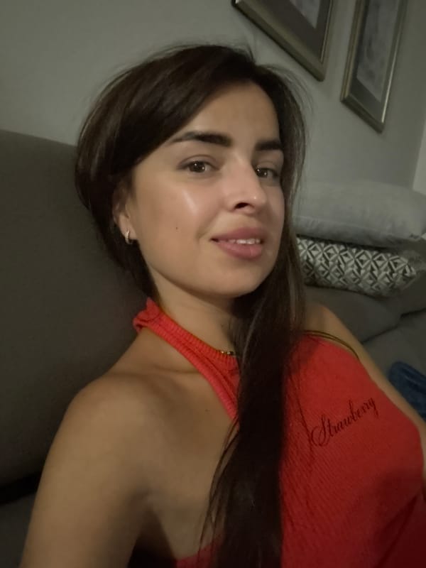Indoor selfie session in a red Strawberry tank top