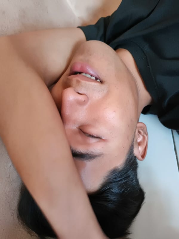 Person rests on floor in Cianjur home during morning