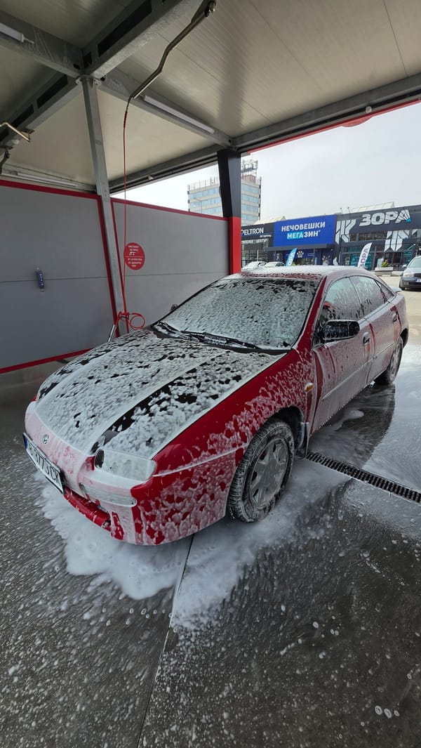 Red car being washed at self-service facility in Varna