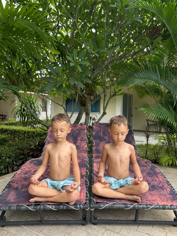 Kids meditating on an outdoor lounge chair in Ko Samui