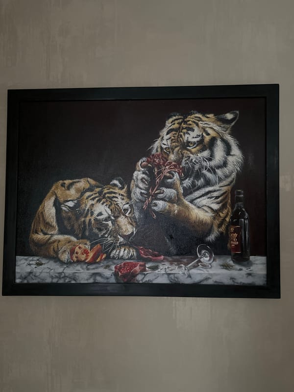 Tiger painting and sleeping cat observed in domestic setting