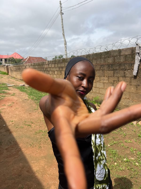 Outdoor portrait session against a brick wall in Bukuru