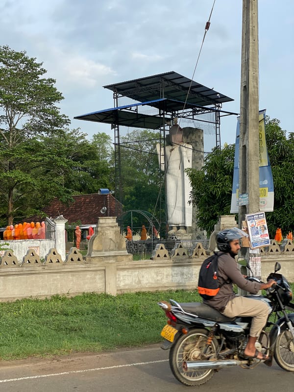 Buddha statue construction continues amid traditional Sri Lankan landscape
