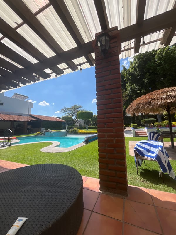 Residential backyard spaces with pool and landscaped areas documented