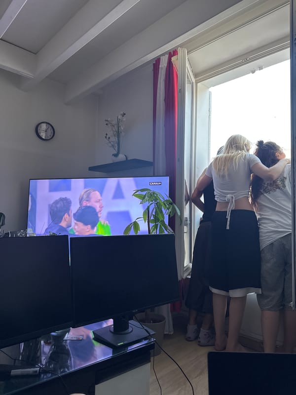 Three people watch from Paris balcony door