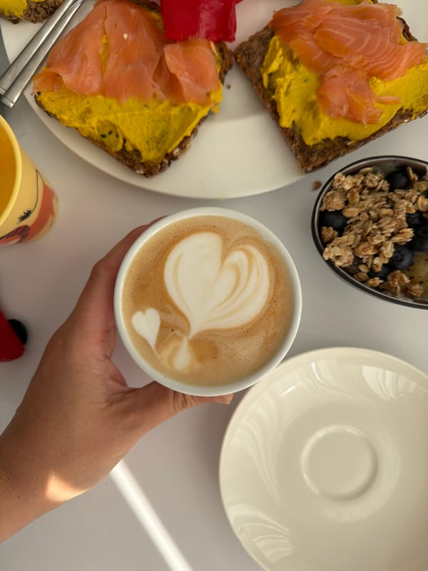Morning breakfast spread with latte art and open-faced sandwiches