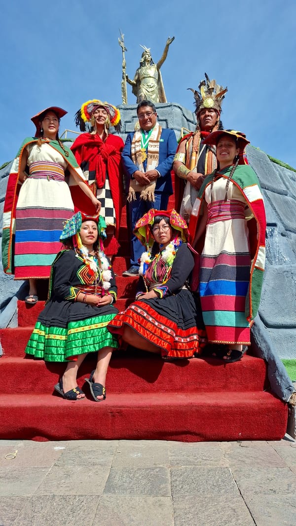 Group in Andean attire poses for outdoor photograph