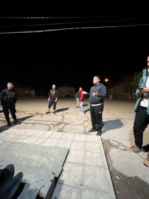 Young men play casual nighttime football in Karavelovo, Bulgaria