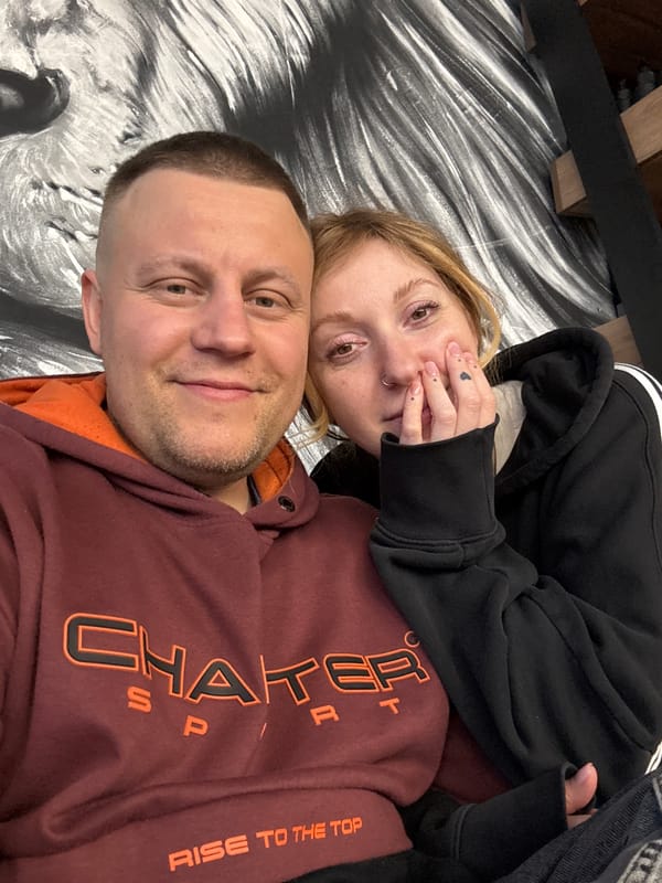 Two people pose for indoor photo in Minsk