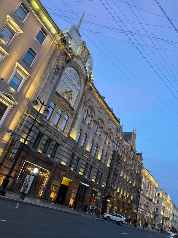 Ornate city street at dusk, blue hour setting in.
