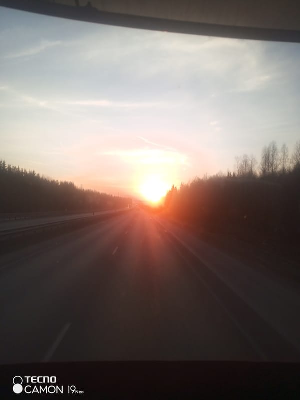 Driver captures sunset view on Russian highway near forests