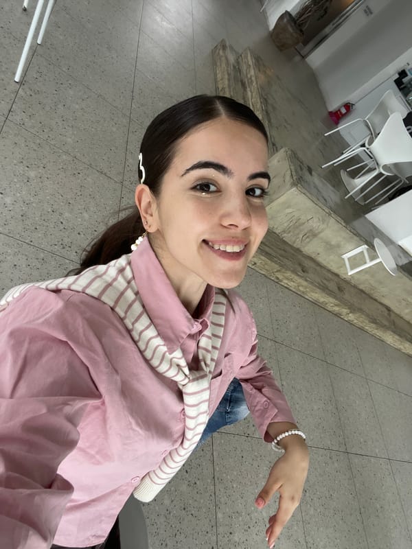 Woman in pink outfit photographed smiling in Busan