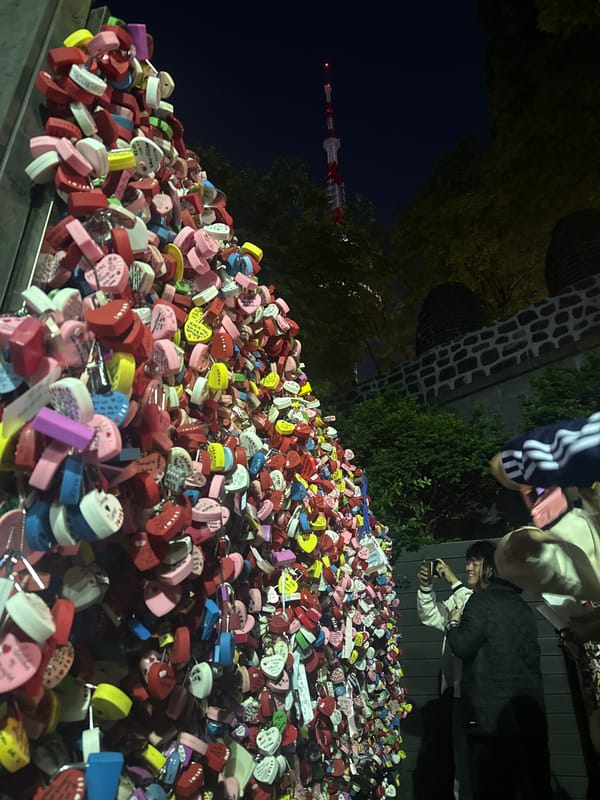 Evening visitors explore colorful love locks at N Seoul Tower