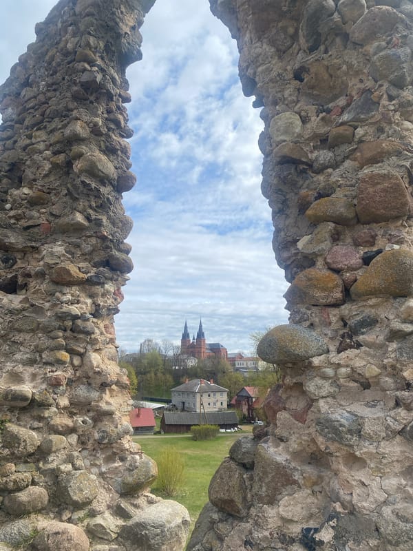 Tourist explores historic Rezekne castle ruins and church views