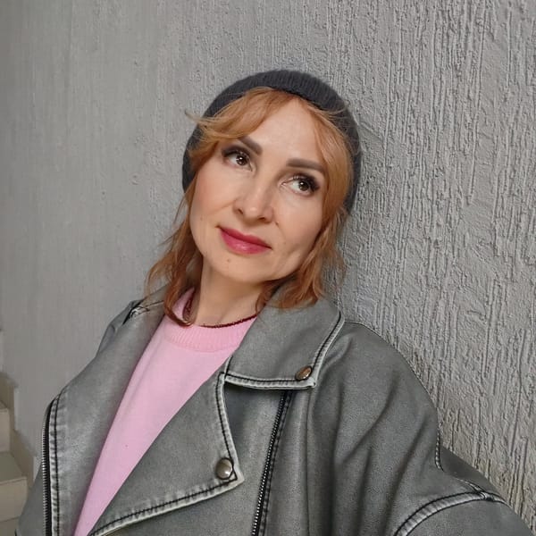 Woman photographs herself near construction vehicles in Chaikovsky