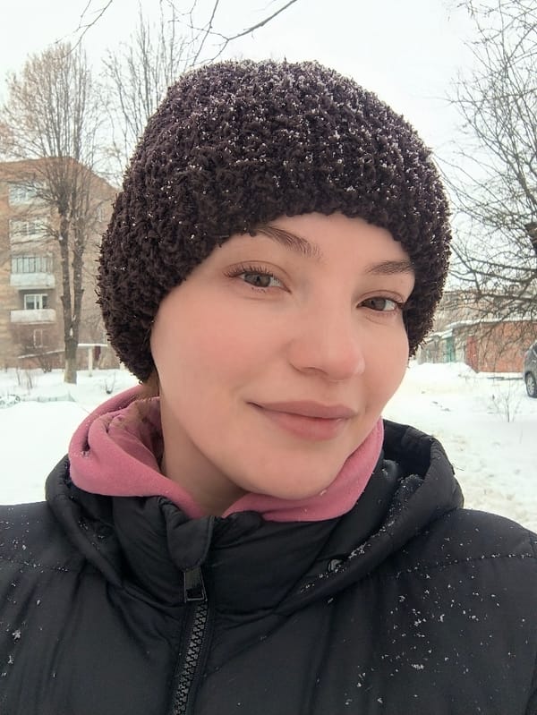 Woman and cat captured in winter snowfall, Vinnytsia