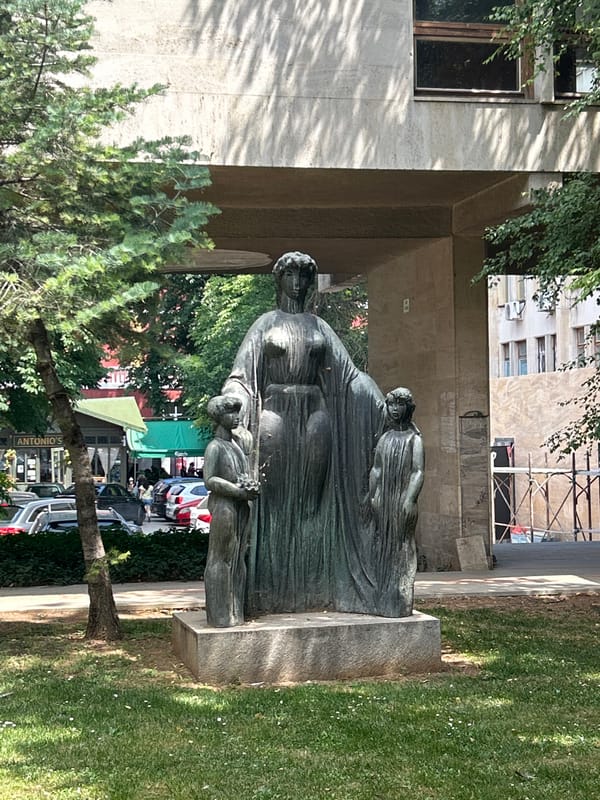 City morning: café food, street scenes, and a bronze sculpture