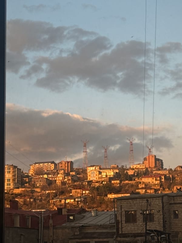 Yerevan hillside residential buildings observed under cloudy skies