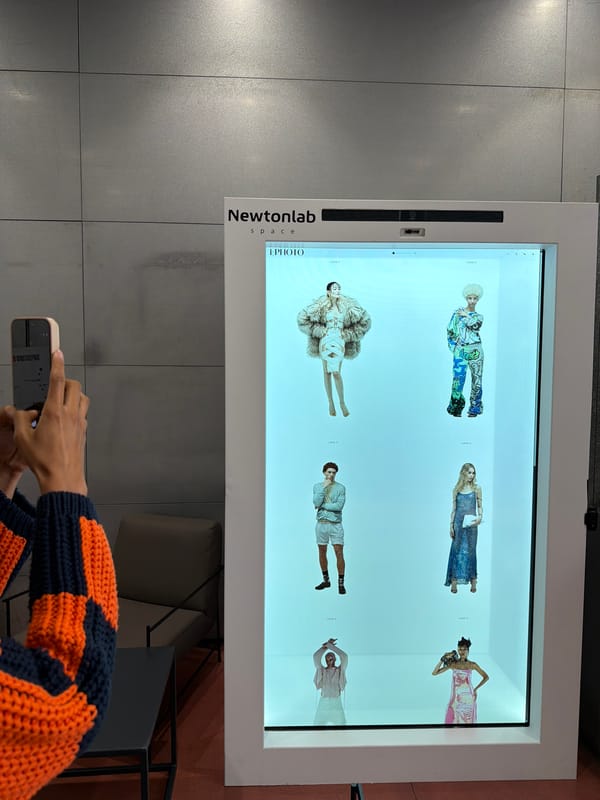 People interact with digital fashion displays in Milan