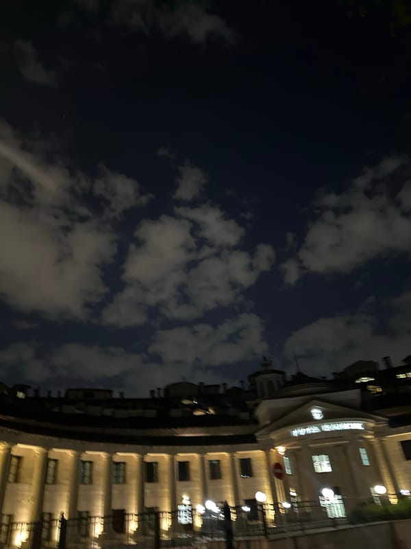 Urban building observed at night with lit windows
