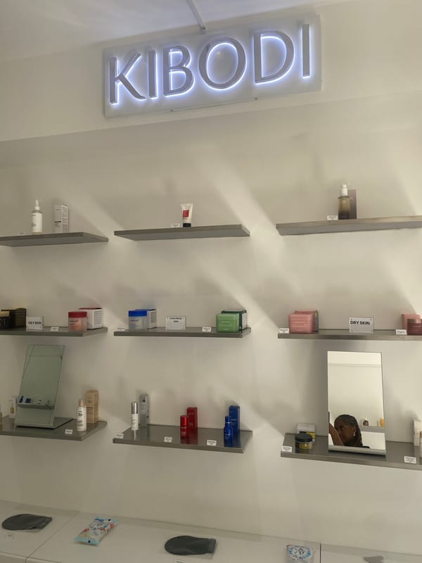 Customer browses cosmetics at London beauty store, displays colorful nail art