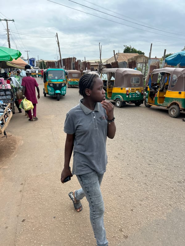 Street vendors and shoppers fill a busy outdoor market