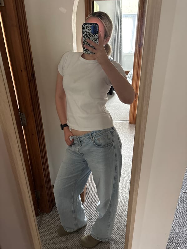 Person takes mirror selfie in Manchester wearing casual attire