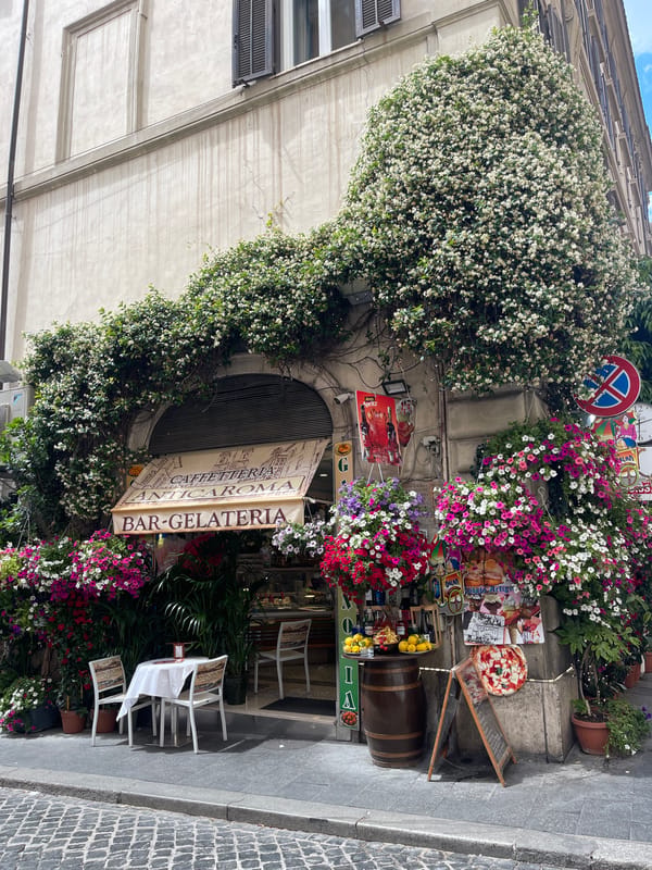 Tourist documents flower-decorated Rome landmarks during morning walkabout