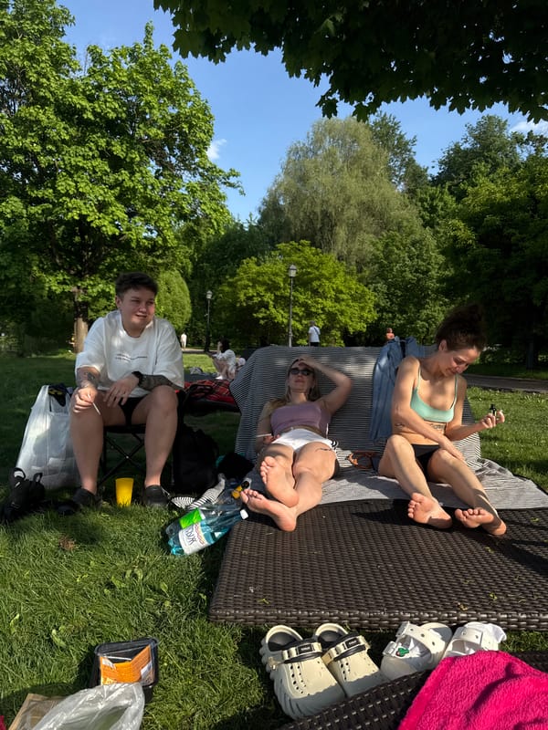 Three People Enjoy Sunny Afternoon in Moscow Park
