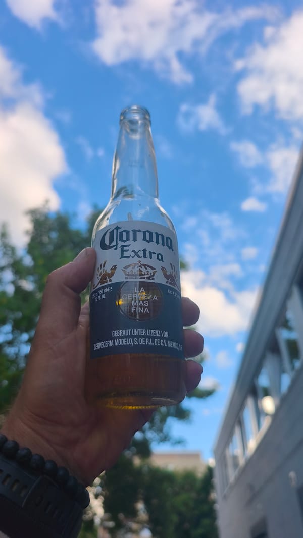 Man enjoys Corona beer outdoors under summer sky