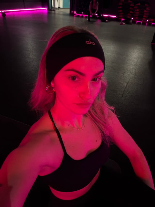 Woman takes gym selfies in neon-lit Salford fitness center