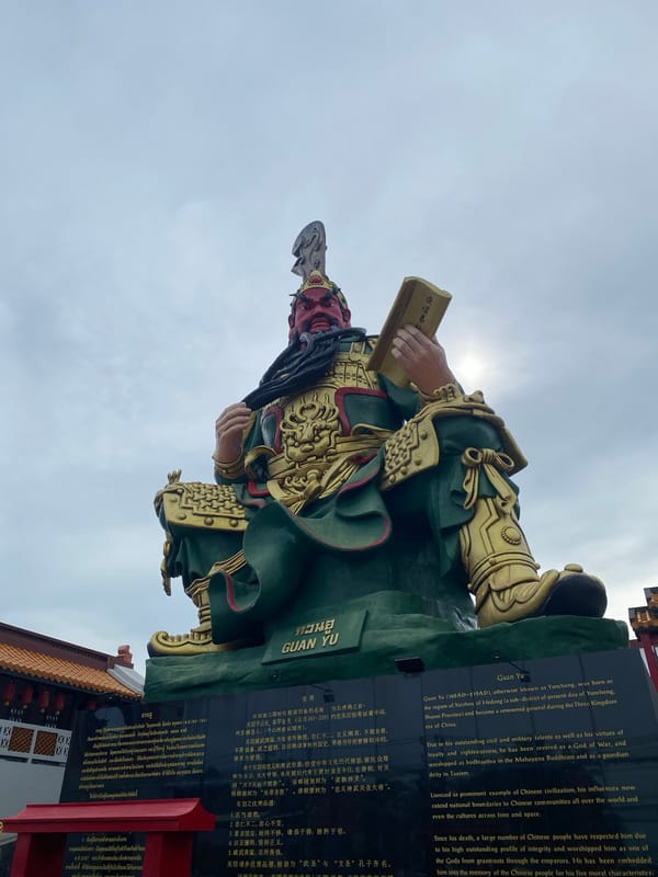 Guan Yu shrine and a vintage red bicycle in Baan Hua Thanon