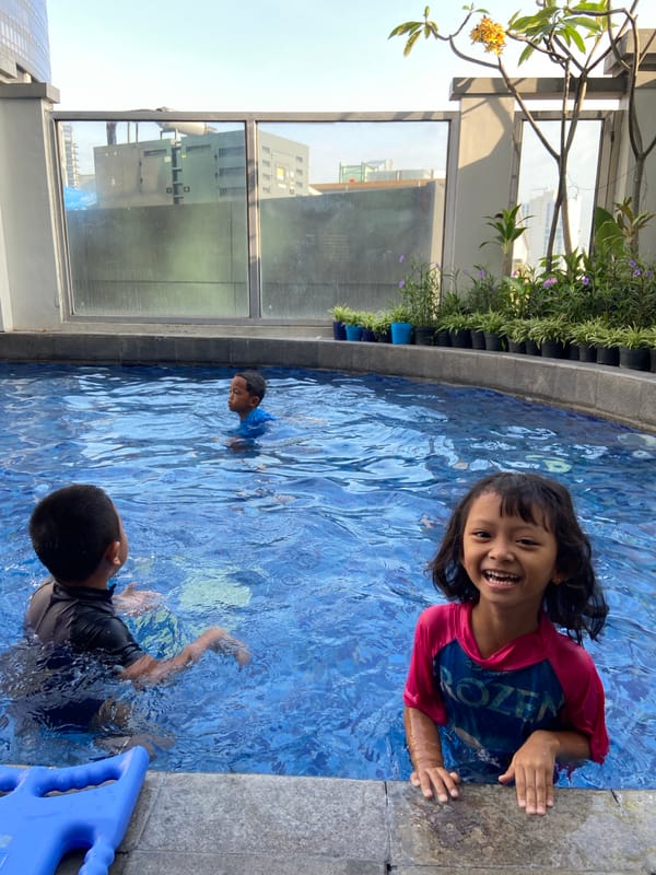 Children swim in rooftop pool in Surabaya