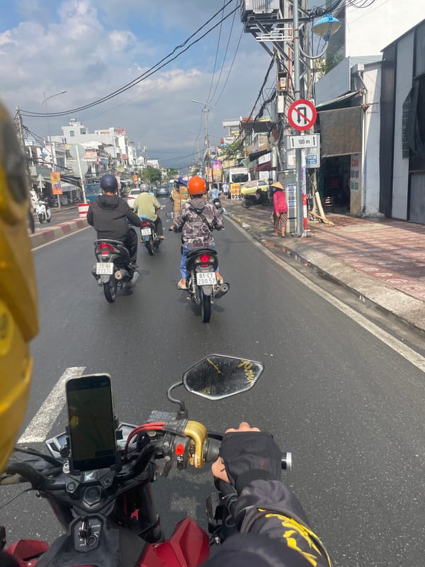 Motorbike traffic navigates wet streets in Nha Trang