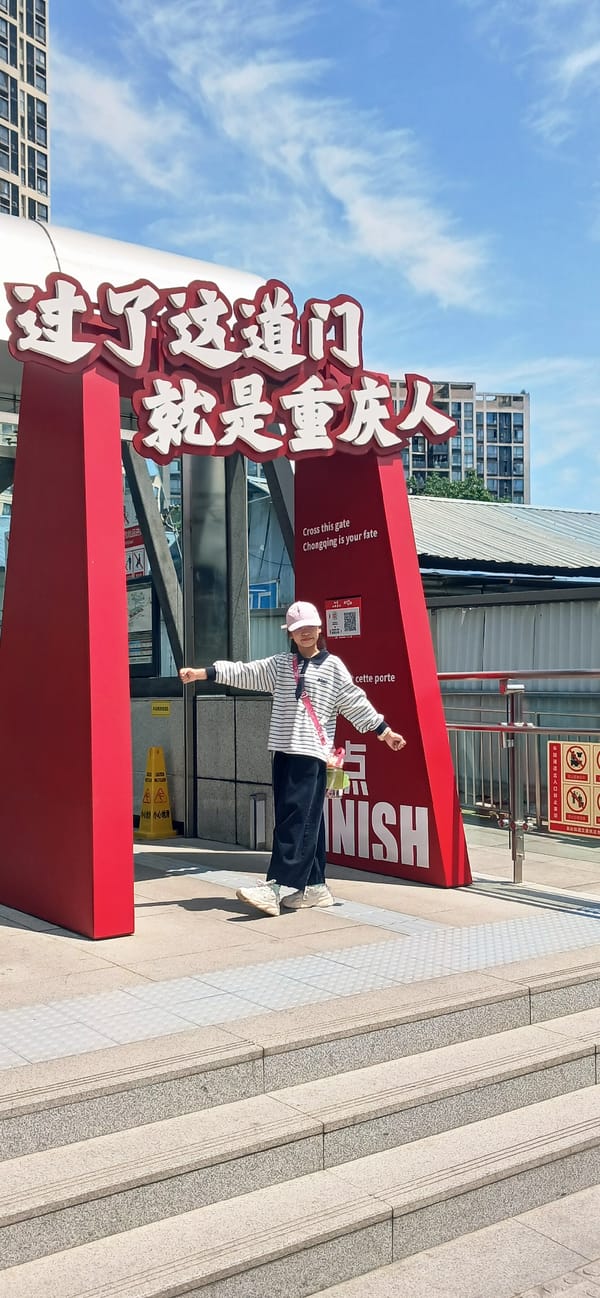 Woman poses by bilingual gate sign in Chongqing