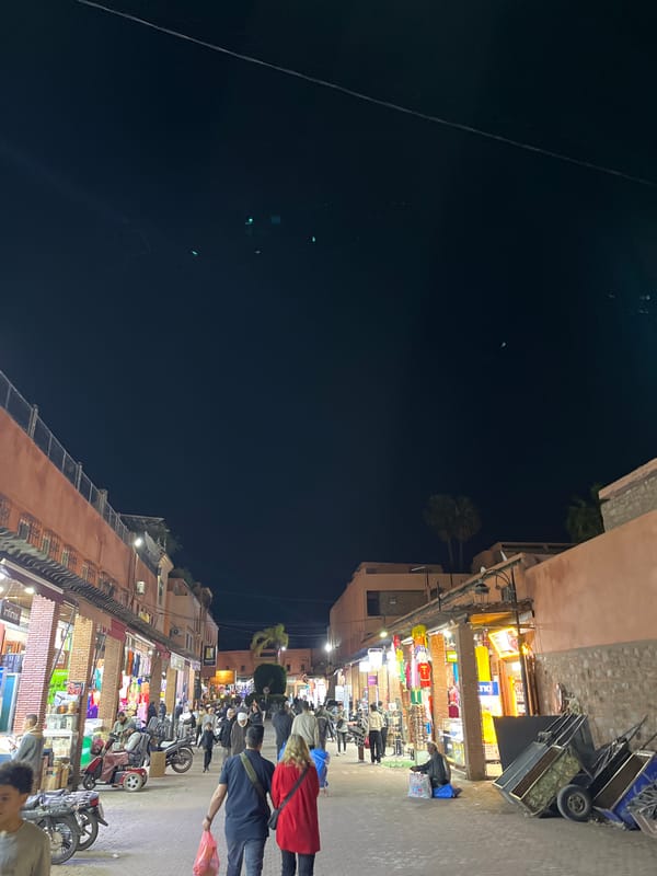 Night market activity observed in busy Marrakesh street