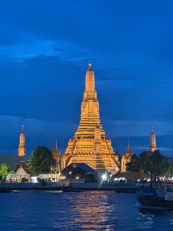 Wat Arun glowing at dusk along the Chao Phraya