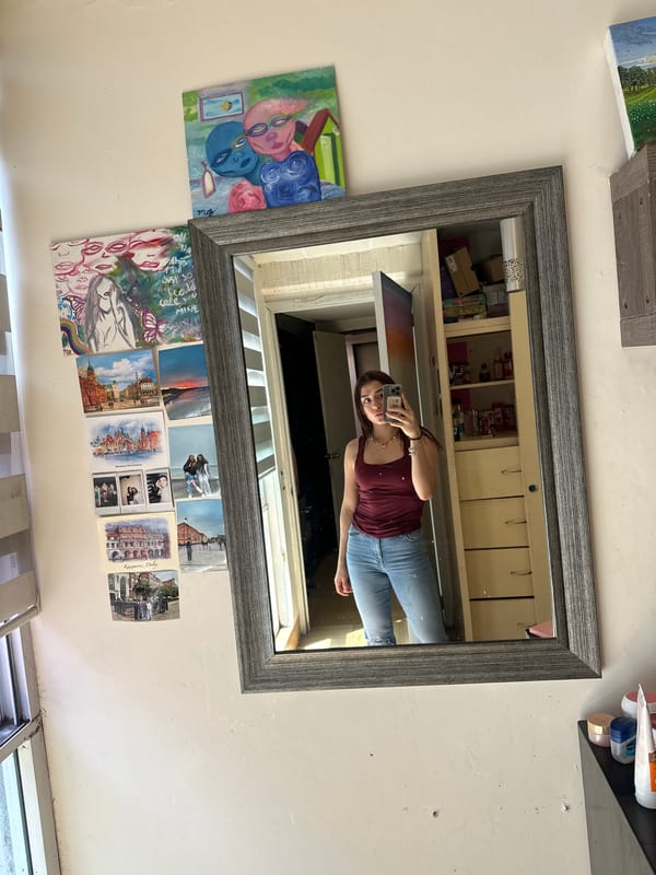 Woman takes mirror selfie in decorated room in Puebla
