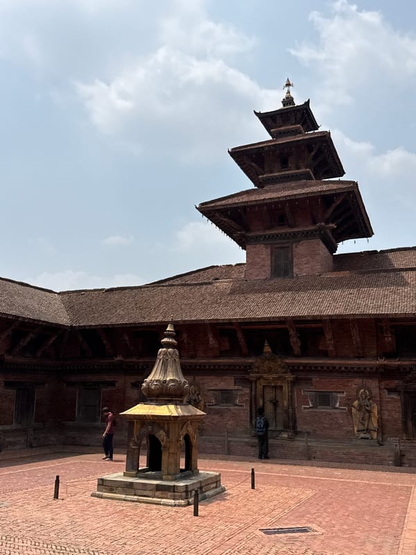 Tourist documents historic temples and sculptures at Patan Durbar Square