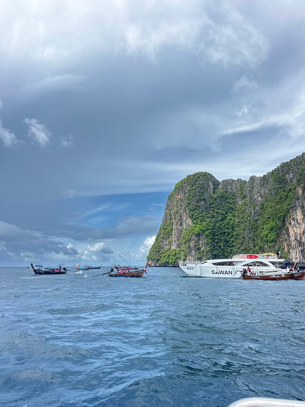 Longtail boats weaving through Koh Phi Phi's limestone karst waters
