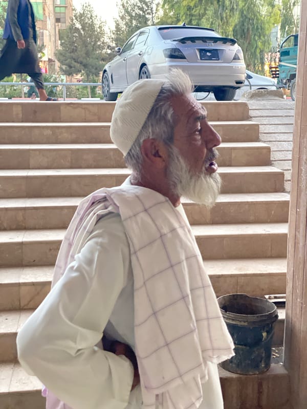 Street-level moments near a stairway in Kandahar