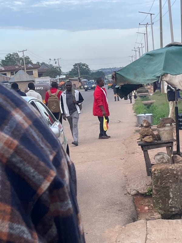 Everyday street activity along a paved road in Jos, Nigeria