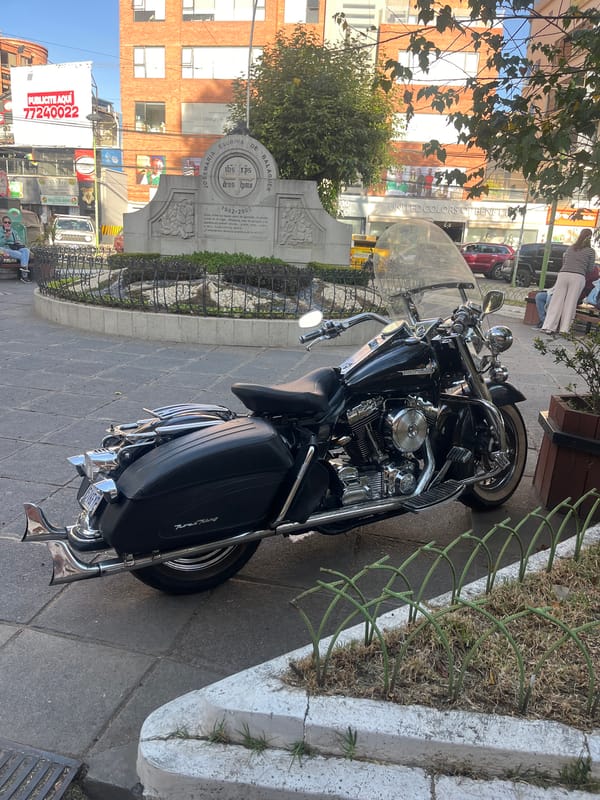 Motorcycle parked near Josemaria Escriva monument in La Paz