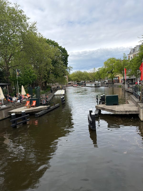 Amsterdam canal photographed under overcast skies, May 2026