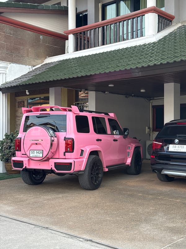 Hot pink modified SUV parked at Ko Samui building