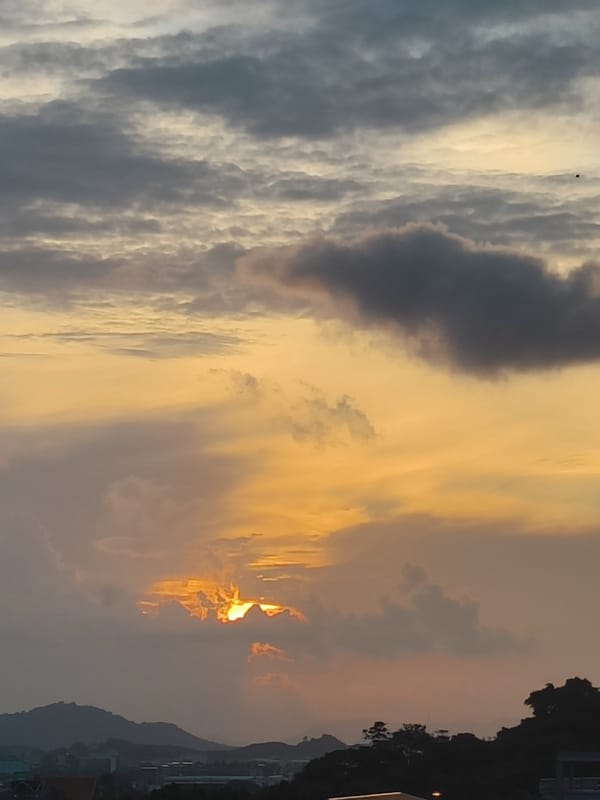 City sunset with dramatic cloud colors across the skyline