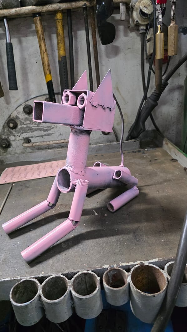 Pink Metal Horse Sculpture Spotted on Workshop Bench