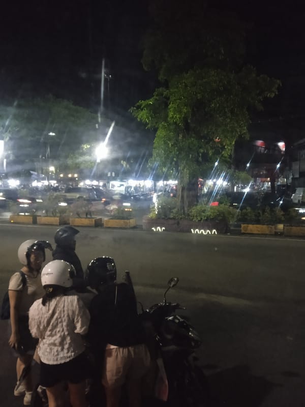 Evening scenes captured in Madiun: motorcyclists and train passengers