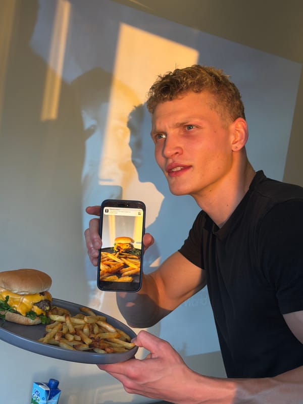 Cheeseburger and fries, phone in hand, London evening