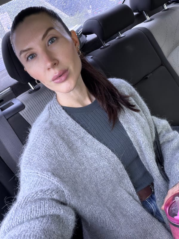Woman with pink water bottle observed in car backseat, Perm